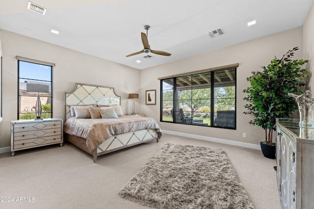 bedroom with ceiling fan and light colored carpet