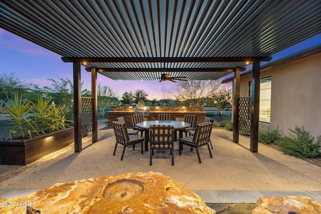 view of patio terrace at dusk