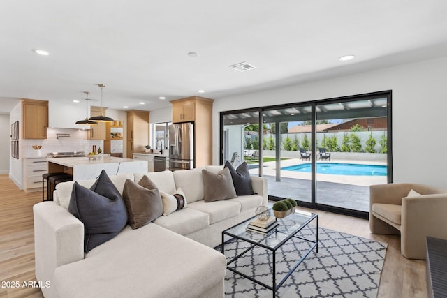 4842 E Surrey Ave, Scottsdale, AZ 85254 - living room featuring light wood-type flooring and recessed lighting