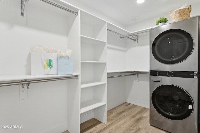 4842 E Surrey Ave, Scottsdale, AZ 85254 - laundry room with stacked washer / drying machine and light wood-style flooring