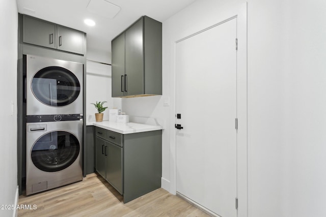 4842 E Surrey Ave, Scottsdale, AZ 85254 - washroom featuring estacked washer and dryer, cabinet space, light wood-style floors, and recessed lighting