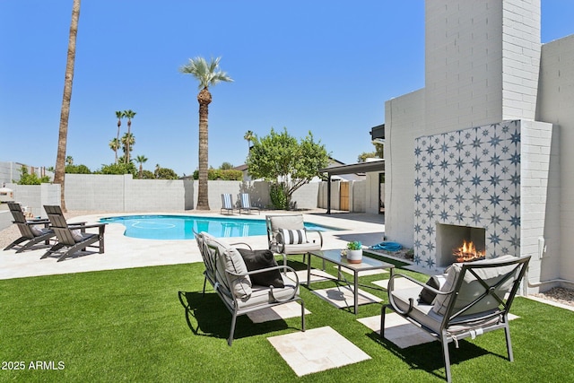 4842 E Surrey Ave, Scottsdale, AZ 85254 - view of swimming pool with a warm lit fireplace, a patio, and a fenced backyard