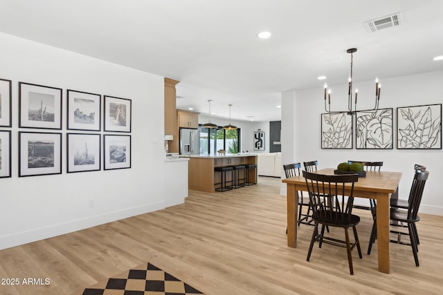 4842 E Surrey Ave, Scottsdale, AZ 85254 - dining space featuring a chandelier, recessed lighting, and light wood-style flooring