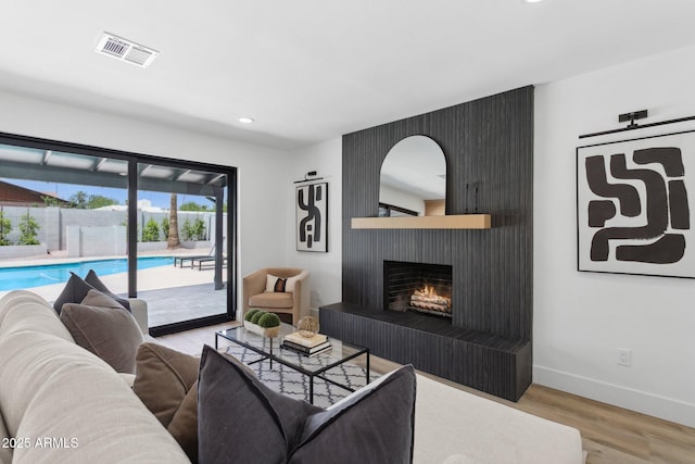 4842 E Surrey Ave, Scottsdale, AZ 85254 - living room featuring wood finished floors, recessed lighting, and a large fireplace