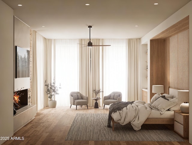 bedroom with hardwood / wood-style flooring and expansive windows