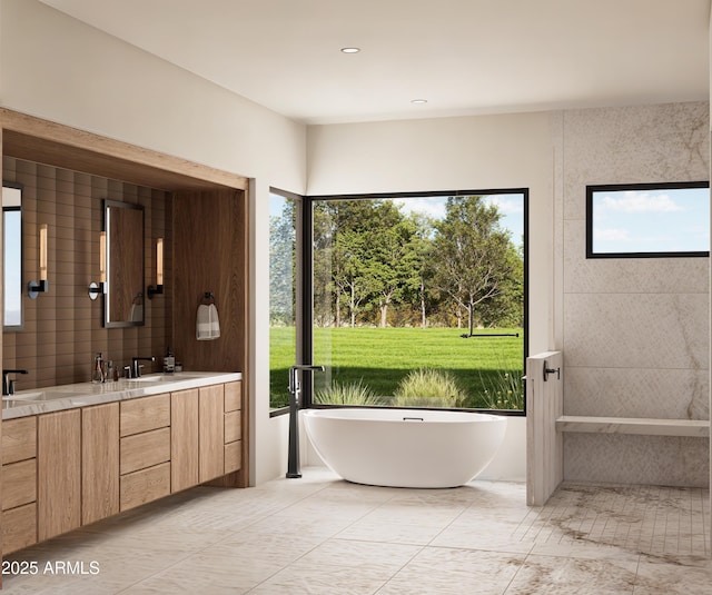 bathroom featuring vanity and a washtub