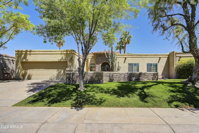 view of front of property with a garage and a front lawn