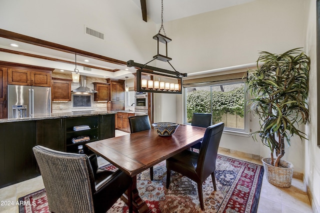 tiled dining area with a towering ceiling