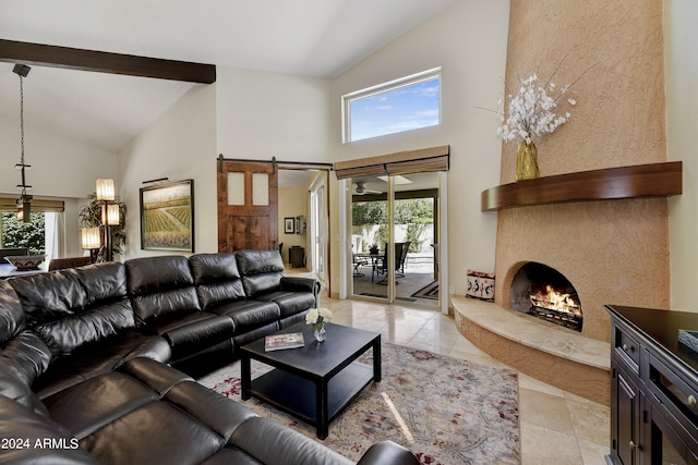 tiled living room featuring plenty of natural light, high vaulted ceiling, and a barn door