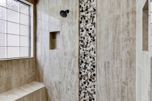 bathroom featuring tiled shower