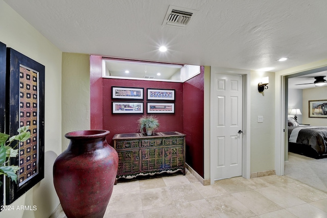 interior space with a textured ceiling and tile flooring