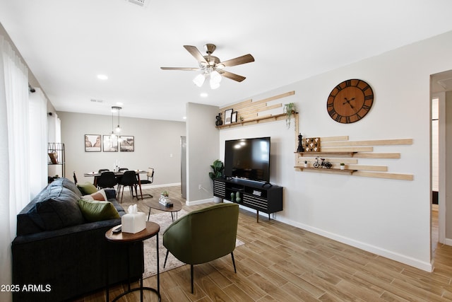 living area featuring visible vents, baseboards, a ceiling fan, wood finished floors, and recessed lighting