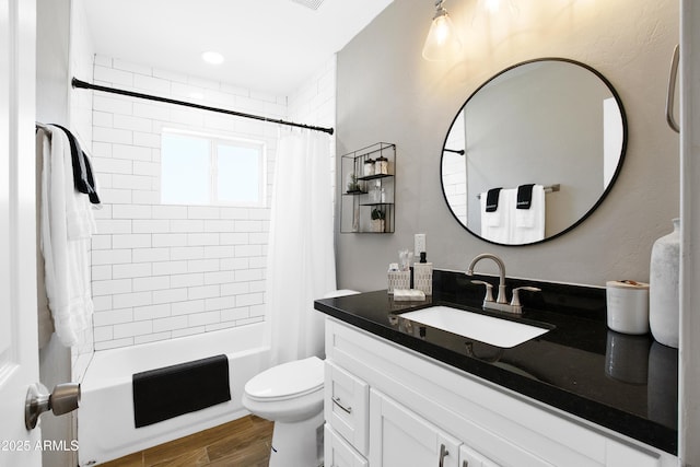 full bath featuring shower / bath combination with curtain, visible vents, toilet, vanity, and wood finished floors