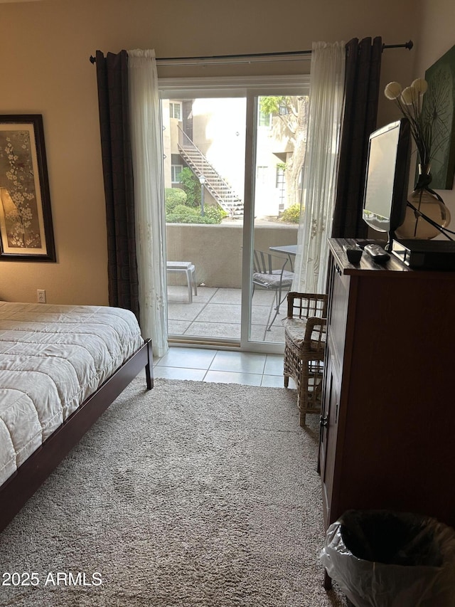 tiled bedroom featuring access to outside