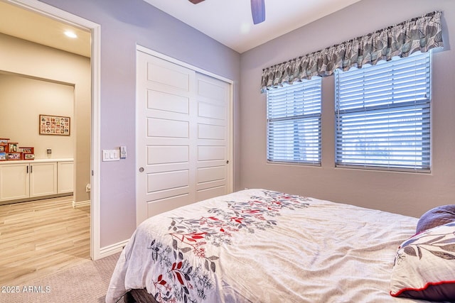 bedroom with ceiling fan and a closet