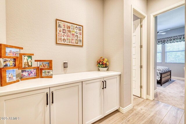 corridor with light hardwood / wood-style flooring