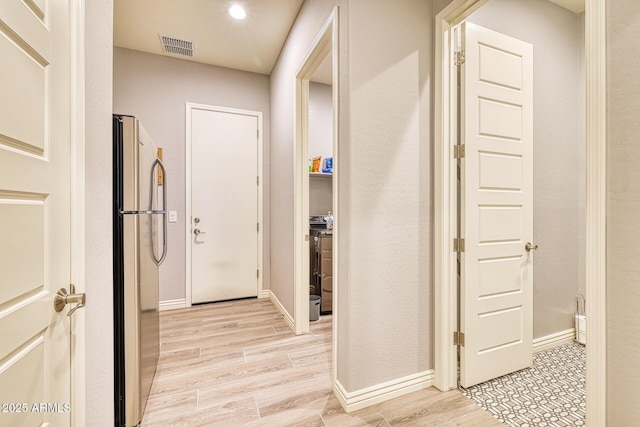 hallway with light wood-type flooring