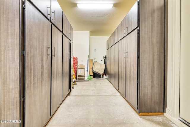 hall featuring a textured ceiling