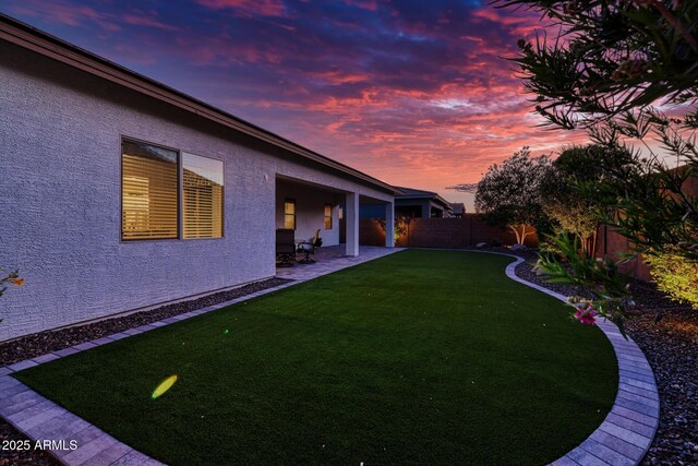 yard at dusk with a patio