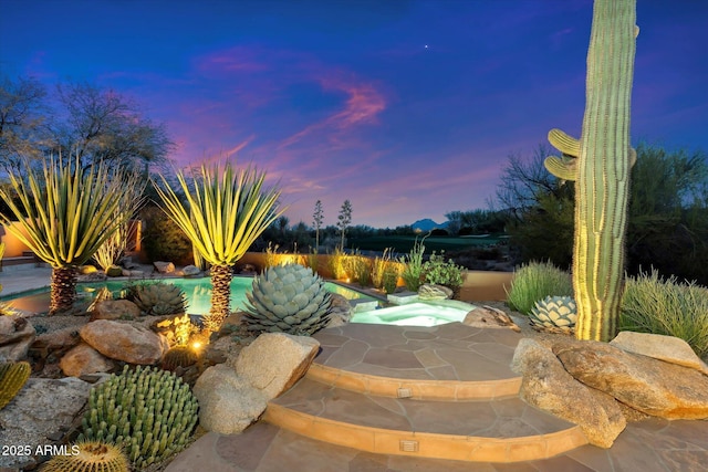 view of patio terrace at dusk