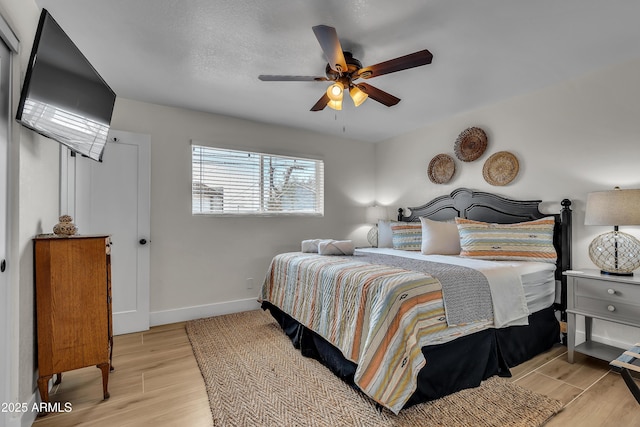 bedroom featuring light hardwood / wood-style floors and ceiling fan