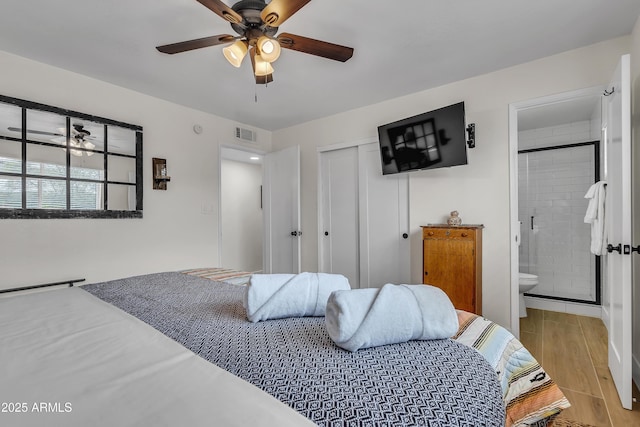 bedroom with ceiling fan, a closet, and ensuite bathroom