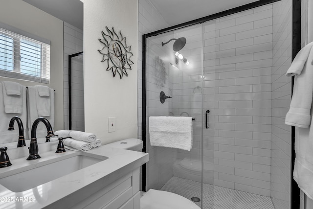 bathroom with toilet, an enclosed shower, and vanity