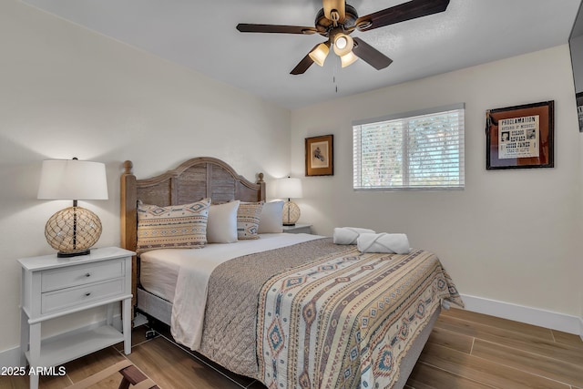 bedroom with ceiling fan and light hardwood / wood-style floors