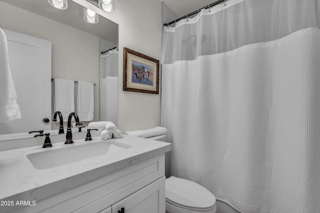 bathroom with toilet and vanity