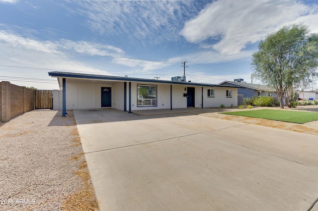 ranch-style home featuring a carport