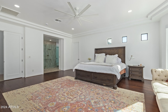 bedroom featuring dark wood-type flooring, ceiling fan, and connected bathroom