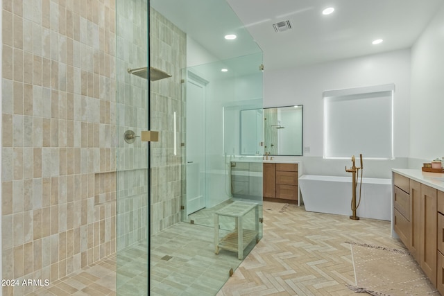 bathroom with plus walk in shower, vanity, and parquet flooring