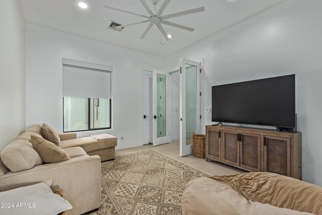 tiled living room featuring french doors and ceiling fan