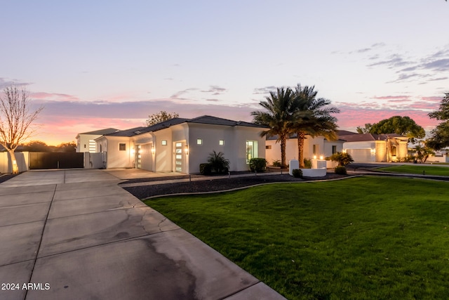 view of front of house with a garage and a yard