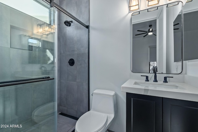 bathroom featuring ceiling fan, vanity, toilet, and an enclosed shower