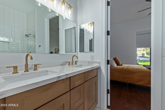 bathroom featuring vanity, hardwood / wood-style flooring, and a tile shower