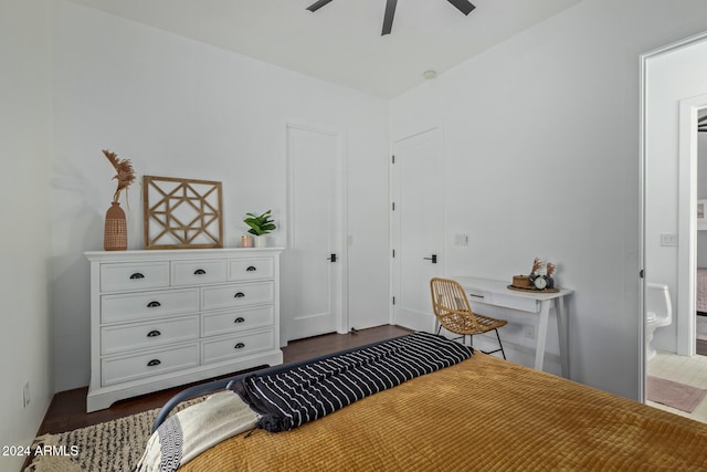 bedroom with ensuite bath, dark hardwood / wood-style floors, and ceiling fan