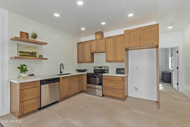 kitchen with stainless steel appliances, light tile patterned floors, sink, and backsplash