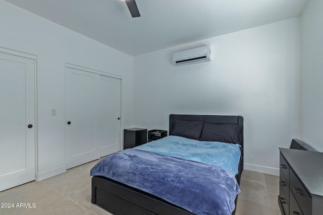 bedroom featuring an AC wall unit, ceiling fan, and light tile patterned floors