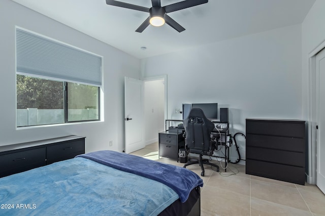 bedroom with ceiling fan and light tile patterned floors