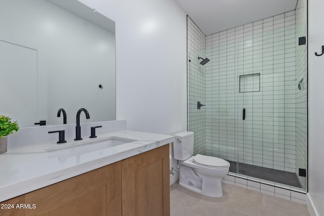 bathroom featuring vanity, tile patterned flooring, toilet, and an enclosed shower