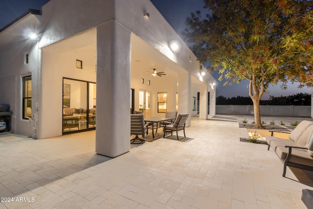 patio terrace at dusk featuring ceiling fan