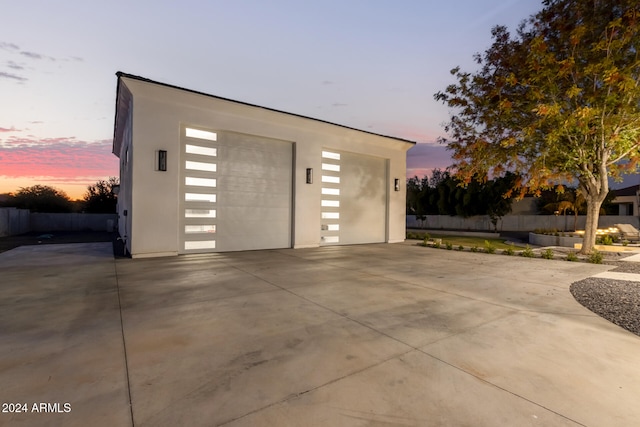 view of garage at dusk