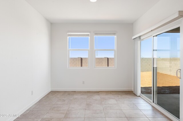 12473 E Bahia Ct, Florence, AZ 85132 - spare room featuring light tile patterned floors, baseboards, and plenty of natural light