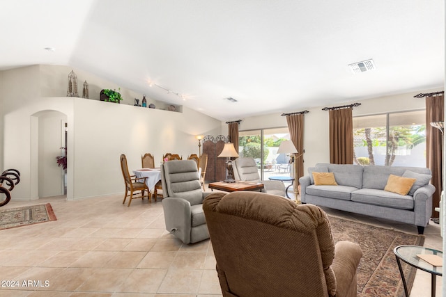 living room featuring light tile patterned floors and vaulted ceiling