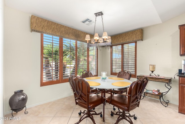 dining space with an inviting chandelier and light tile patterned floors