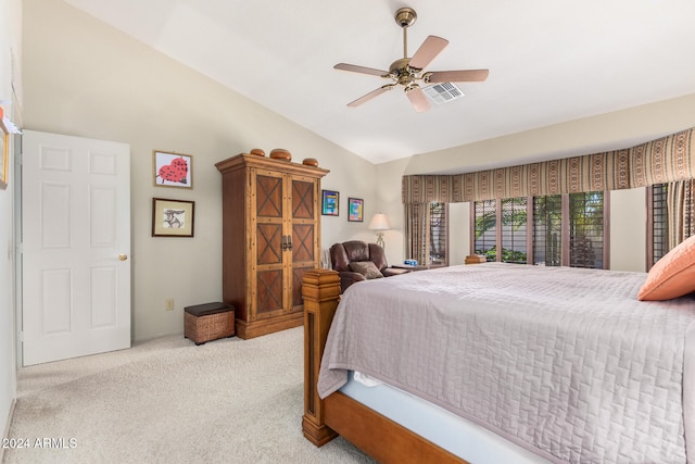 carpeted bedroom with ceiling fan and vaulted ceiling