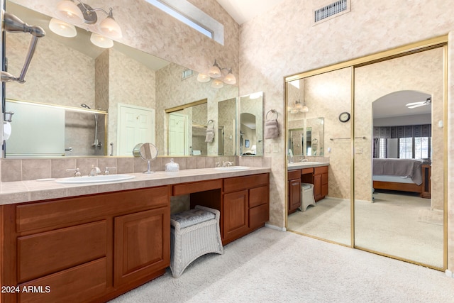 bathroom with vanity, a shower with shower door, and lofted ceiling