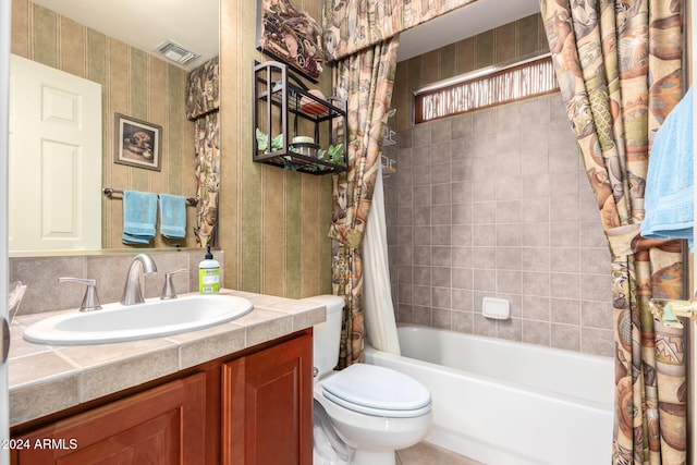 full bathroom with vanity, toilet, and shower / tub combo