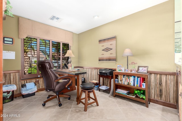 office space with a healthy amount of sunlight, light tile patterned floors, and wood walls